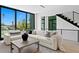 Bright living room with a sectional couch, modern staircase, and large windows offering great natural light at 98 W Davis Blvd, Tampa, FL 33606