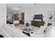 Bright open concept living room featuring a white couch, coffee table, and a kitchen in the background at 98 W Davis Blvd, Tampa, FL 33606