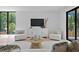 Bright living room with modern decor, light hardwood floors, and large windows at 98 W Davis Blvd, Tampa, FL 33606