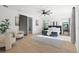 Bright main bedroom featuring a vaulted ceiling, ceiling fan, light wood floors, and a blue bed frame at 98 W Davis Blvd, Tampa, FL 33606