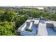 Exclusive rooftop lounge area featuring a cozy seating arrangement amidst lush greenery, offering panoramic city views at 98 W Davis Blvd, Tampa, FL 33606