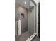 Contemporary shower with gray tiling, glass door, and built-in niche at 98 W Davis Blvd, Tampa, FL 33606