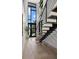 Modern staircase with wood treads, black metal railings, wood floors, and abundant natural light at 98 W Davis Blvd, Tampa, FL 33606