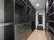 This walk-in closet has dark wood shelving and drawers with bronze colored handles at 98 W Davis Blvd, Tampa, FL 33606
