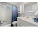 Clean bathroom features a tub, vanity, and a blue patterned shower curtain at 1019 Goshen Rd, Tarpon Springs, FL 34689