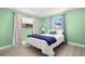 Comfortable bedroom with two windows and a cozy bed with stylish blue accents at 1019 Goshen Rd, Tarpon Springs, FL 34689
