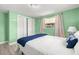Bright bedroom featuring a large window, double door closet, and comfortable bed at 1019 Goshen Rd, Tarpon Springs, FL 34689