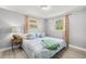 Serene bedroom with ample natural light, calming decor, and wood-look flooring at 1019 Goshen Rd, Tarpon Springs, FL 34689