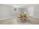 Bright dining area featuring seating for four, natural light, and easy access to a door at 1019 Goshen Rd, Tarpon Springs, FL 34689