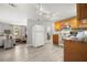 Open-concept kitchen boasts wood cabinets and modern flooring, connecting to the living area at 1019 Goshen Rd, Tarpon Springs, FL 34689