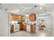 Traditional kitchen featuring wood cabinets, track lighting, and modern appliances with access to the dining room at 1019 Goshen Rd, Tarpon Springs, FL 34689