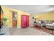 Open living area with colorful decor, wood-look floors, and a view into the kitchen at 1019 Goshen Rd, Tarpon Springs, FL 34689