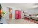 Modern living space with stylish pink armoire, wood-look flooring, and open access to the kitchen at 1019 Goshen Rd, Tarpon Springs, FL 34689