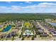 Beautiful aerial view of a suburban neighborhood with a pool, green space and small lake at 11907 Streambed Dr, Riverview, FL 33579