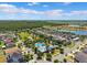 Beautiful aerial view of a neighborhood with a community pool and a lake in the background at 11907 Streambed Dr, Riverview, FL 33579