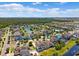 An aerial view of a neighborhood with homes, trees, and a pond, complete with community pool and activity center at 11907 Streambed Dr, Riverview, FL 33579