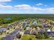 An aerial view of residences in a community featuring landscaped lawns and a wooded backdrop at 11907 Streambed Dr, Riverview, FL 33579