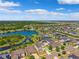 An aerial view of a lakefront community featuring single-Gathering homes and manicured lawns at 11907 Streambed Dr, Riverview, FL 33579