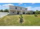 View of the home's back exterior with an open patio and lush green space at 11907 Streambed Dr, Riverview, FL 33579