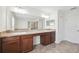 Bright bathroom featuring double vanities and neutral tiling at 11907 Streambed Dr, Riverview, FL 33579