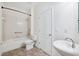 Clean, white bathroom with tiled shower and bathtub, toilet, and sink basin with chrome faucet at 11907 Streambed Dr, Riverview, FL 33579