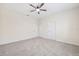 Spacious carpeted bedroom with ceiling fan and multiple doors at 11907 Streambed Dr, Riverview, FL 33579