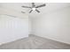 Neutral carpeted bedroom featuring a ceiling fan and a closet with double doors at 11907 Streambed Dr, Riverview, FL 33579