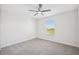 Bright, carpeted bedroom featuring a ceiling fan and a window for natural light at 11907 Streambed Dr, Riverview, FL 33579