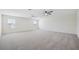 Large bonus room is carpeted and has natural light from multiple windows at 11907 Streambed Dr, Riverview, FL 33579