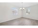 Dining room with laminate floors, chandelier and bright windows at 11907 Streambed Dr, Riverview, FL 33579