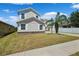 Two-story home featuring a well-maintained lawn, stone foundation, and a small palm tree at 11907 Streambed Dr, Riverview, FL 33579