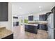 Beautiful kitchen featuring granite countertops, stainless steel appliances, and dark cabinetry at 11907 Streambed Dr, Riverview, FL 33579