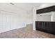 Open space between a hallway and kitchen nook with dark cabinets and matching countertops at 11907 Streambed Dr, Riverview, FL 33579