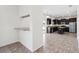 Spacious kitchen with dark cabinets, granite countertops, stainless appliances and breakfast bar open to additional rooms at 11907 Streambed Dr, Riverview, FL 33579