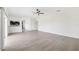 Spacious open-plan living area with hard surface floors and connecting kitchen area at 11907 Streambed Dr, Riverview, FL 33579