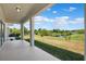 Covered patio has views of the lawn and surrounding water and foliage at 11907 Streambed Dr, Riverview, FL 33579