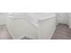 Bright staircase with white walls, white railing, and gray wood flooring at 11907 Streambed Dr, Riverview, FL 33579