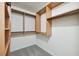 Custom wood shelving and rods maximize storage in this walk-in closet at 11907 Streambed Dr, Riverview, FL 33579