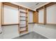 Custom wood shelving and rods maximize storage in this walk-in closet at 11907 Streambed Dr, Riverview, FL 33579