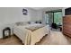 Comfortable bedroom featuring sliding door to a screened-in patio at 12155 Environmental Dr # 3, New Port Richey, FL 34654