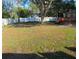 Expansive fenced backyard with mature trees offering ample space for outdoor activities at 125 80Th N Ave, St Petersburg, FL 33702