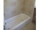 Tiled bathtub with shower in a bathroom renovation at 125 80Th N Ave, St Petersburg, FL 33702