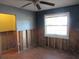 Bedroom featuring a ceiling fan, natural light from the window, and wood-look flooring under renovation at 125 80Th N Ave, St Petersburg, FL 33702