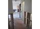Hallway that leads to the kitchen featuring wood-look floors and natural light, currently under renovation at 125 80Th N Ave, St Petersburg, FL 33702