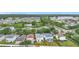 An aerial view of the neighborhood showcasing lush green spaces and the nearby commercial areas and the pond at 12508 Evington Point Dr, Riverview, FL 33579