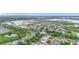 This aerial view shows neighborhood location near ponds, schools, shopping and many trees at 12508 Evington Point Dr, Riverview, FL 33579