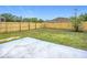 Fenced back yard features grass with a small patio and fresh wooden fencing at 12508 Evington Point Dr, Riverview, FL 33579
