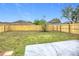 Large, fenced backyard, with lush grass, a concrete patio, and a freshly stained wood fence at 12508 Evington Point Dr, Riverview, FL 33579