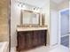 Bathroom with ornate vanity with double sinks, decorative mirror, and modern fixtures at 12508 Evington Point Dr, Riverview, FL 33579