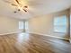Spacious bedroom with laminate floors, multiple windows, and a ceiling fan providing comfort at 12508 Evington Point Dr, Riverview, FL 33579